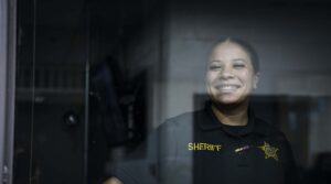 Deputy at a window and smiling
