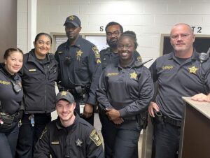Deputies standing next to each other and smiling